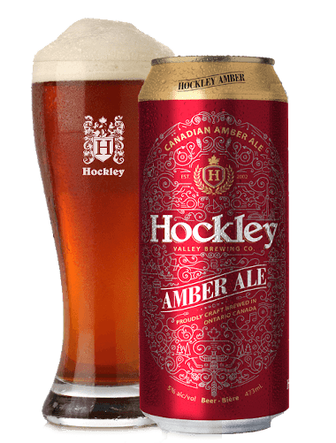 can of hockley amber ale beside and to the front of a glass of freshly poured amber ale