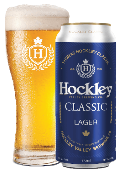 can of hockley classic lager off to the side and in front of a glass freshly poured with hockley classic